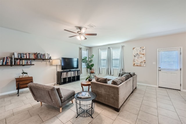 tiled living room with ceiling fan