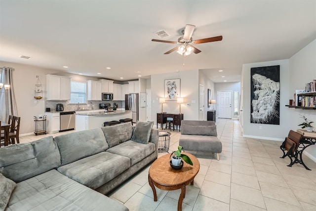 living room featuring ceiling fan and light tile patterned floors