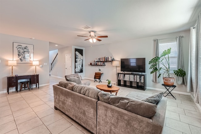 living room featuring light tile patterned floors and ceiling fan