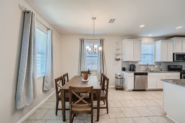 interior space with sink, plenty of natural light, and a chandelier