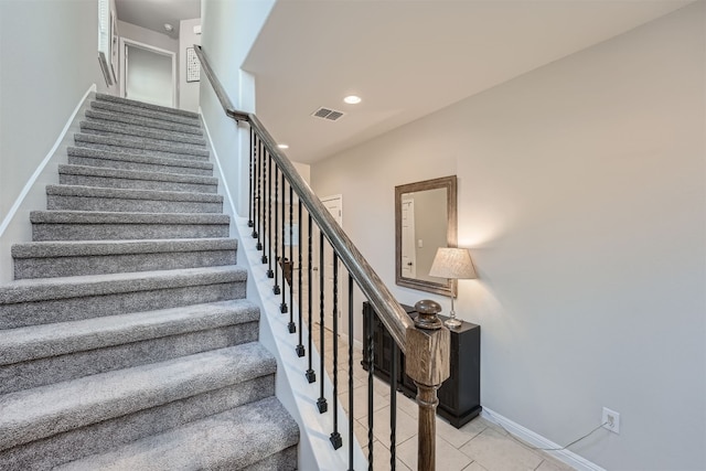 staircase featuring tile patterned flooring