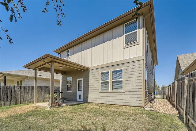 rear view of house featuring a lawn and a patio area