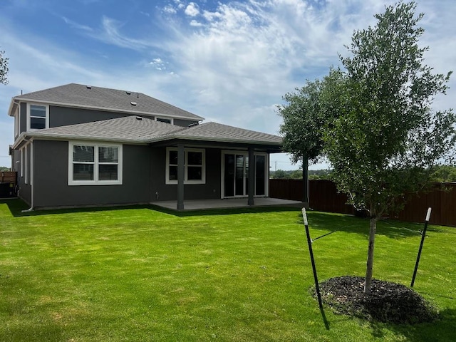 552 Raleigh Dr, Georgetown, TX 78633 - back of property with fence, a patio area, roof with shingles, and a yard