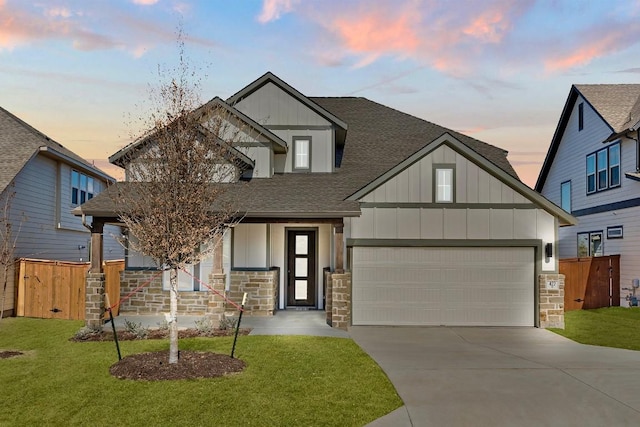 craftsman inspired home with a garage and a lawn