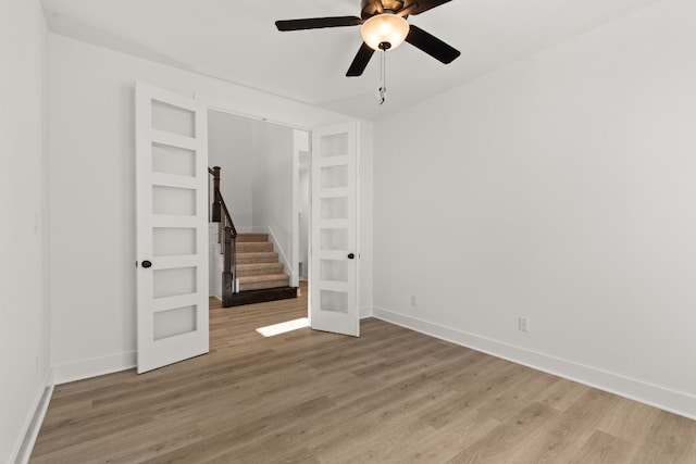 empty room with hardwood / wood-style floors, ceiling fan, and french doors