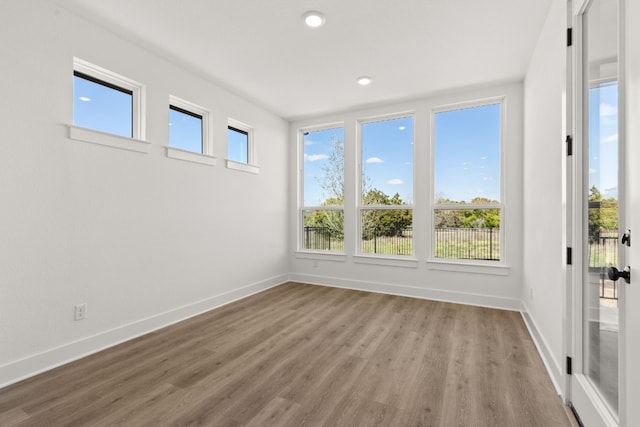 spare room with hardwood / wood-style floors