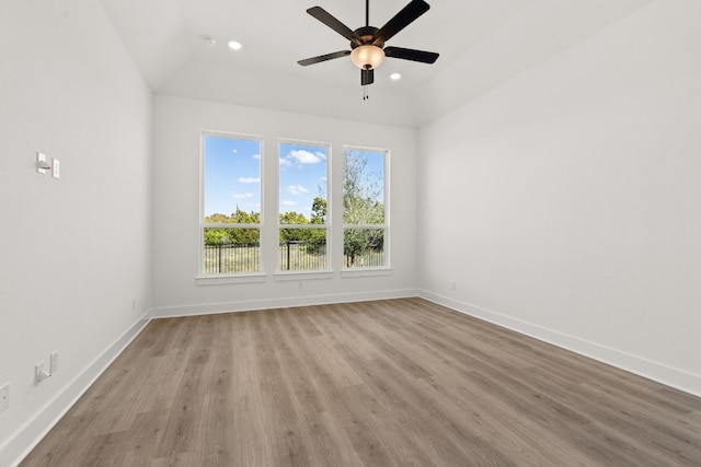 unfurnished room with vaulted ceiling, ceiling fan, and light hardwood / wood-style flooring