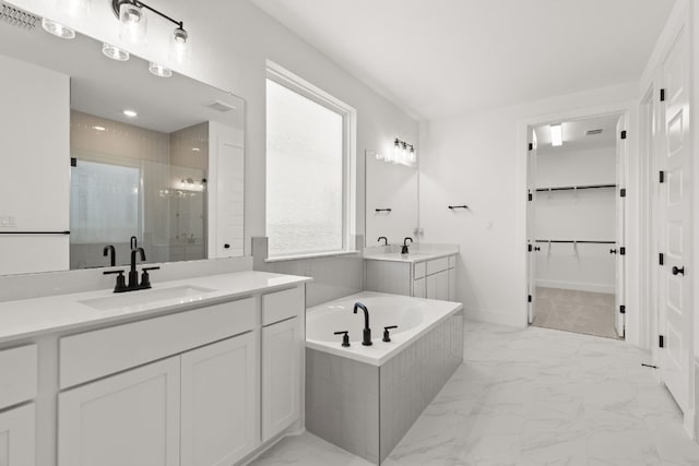 bathroom featuring vanity and shower with separate bathtub