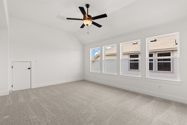 carpeted empty room featuring ceiling fan and vaulted ceiling