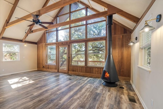 unfurnished living room with high vaulted ceiling, a wood stove, beamed ceiling, and dark hardwood / wood-style flooring