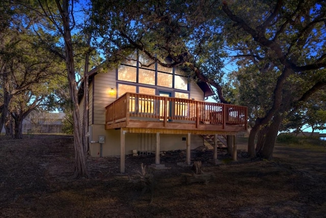 rear view of house featuring a wooden deck