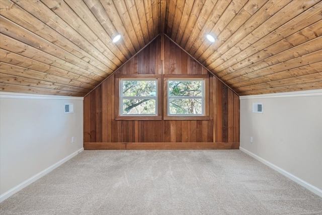 additional living space with carpet, wood walls, vaulted ceiling, and wooden ceiling