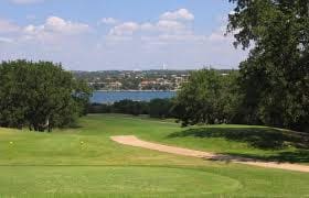 view of property's community with golf course view, a water view, and a lawn