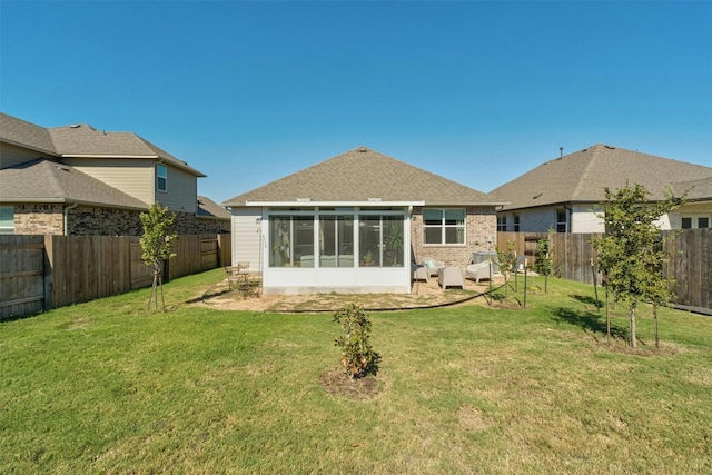 rear view of property with a fenced backyard, a patio, and a yard