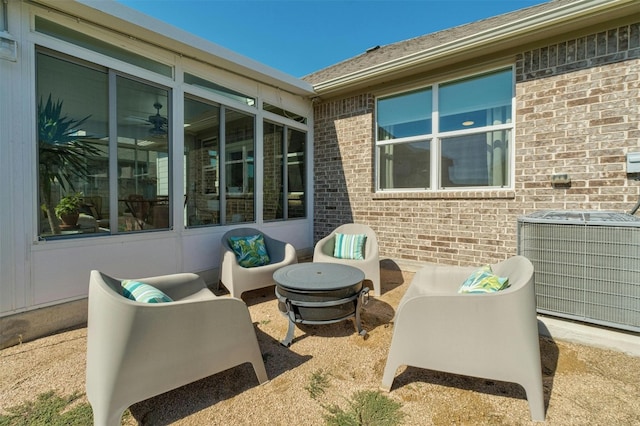 view of patio featuring an outdoor living space with a fire pit and central AC unit