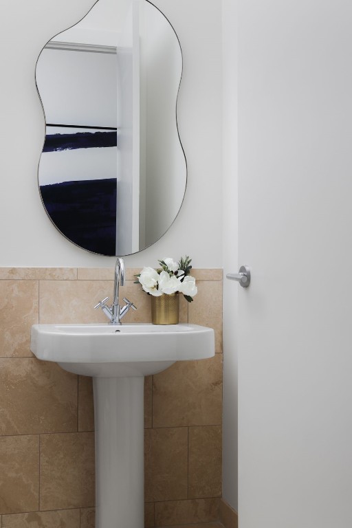 bathroom with tile walls