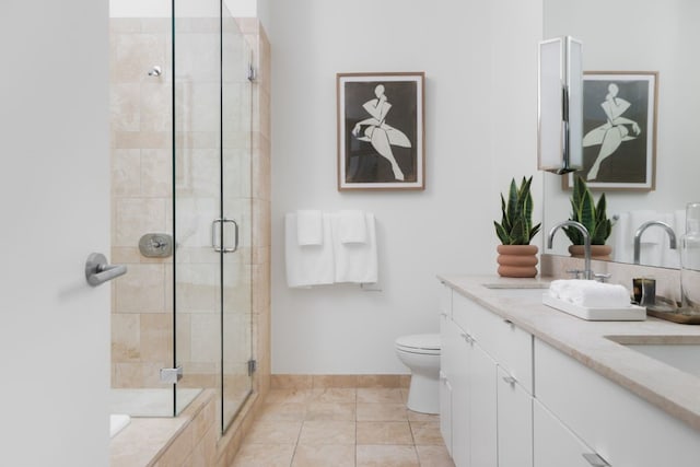 bathroom with vanity, a shower with shower door, toilet, and tile patterned floors