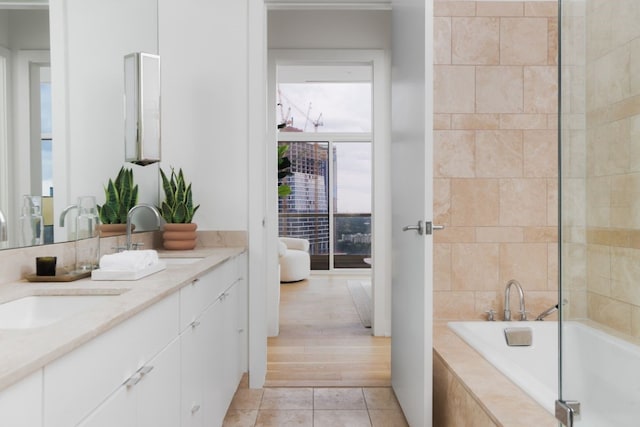 bathroom with vanity, tiled bath, and hardwood / wood-style flooring