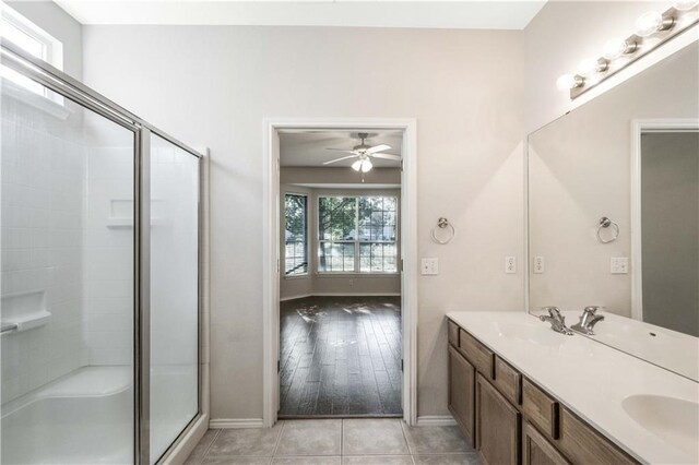 bathroom featuring vanity, ceiling fan, walk in shower, and hardwood / wood-style floors