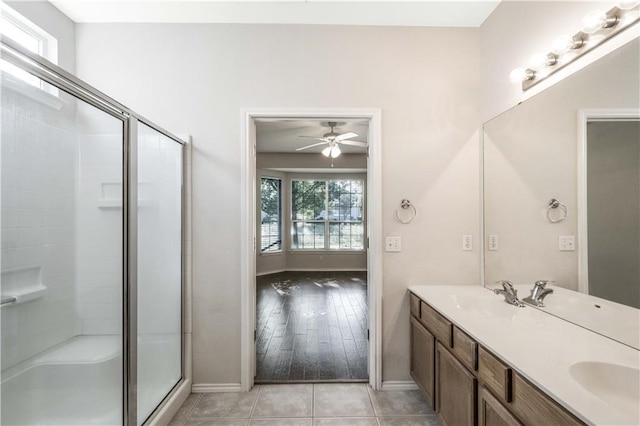 bathroom featuring tile patterned flooring, vanity, an enclosed shower, and ceiling fan