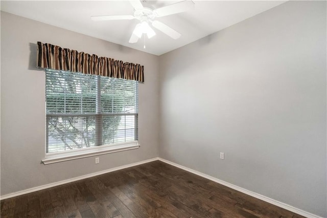 spare room with dark hardwood / wood-style flooring and ceiling fan