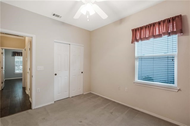 unfurnished bedroom featuring a closet, ceiling fan, and carpet floors