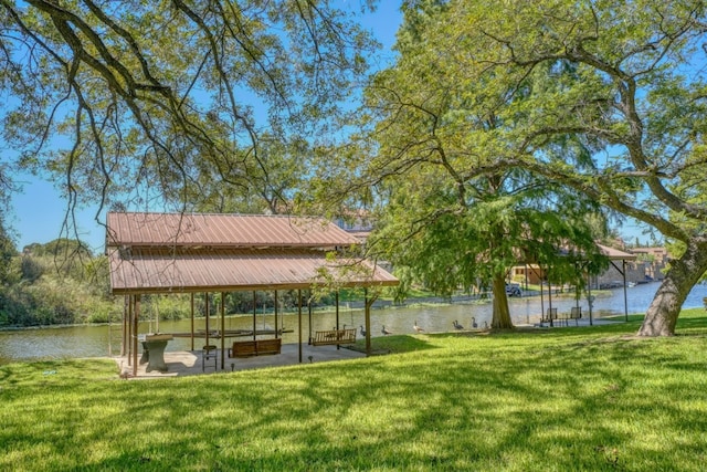 exterior space with a yard, a water view, and a patio area