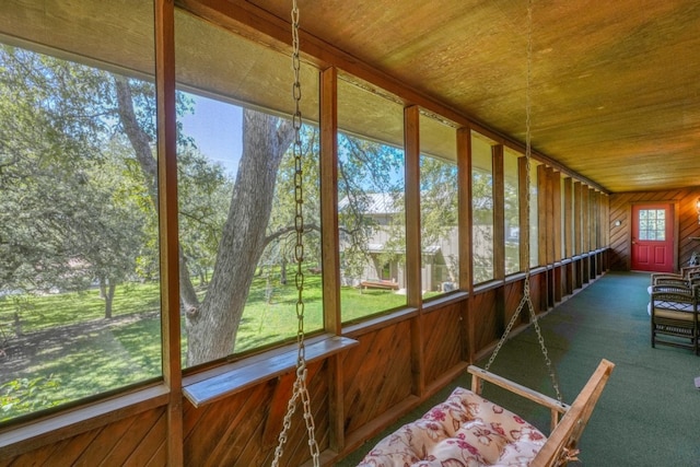 unfurnished sunroom featuring wood ceiling