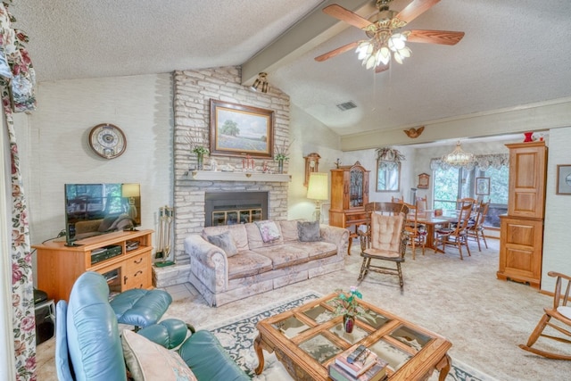 carpeted living room featuring ceiling fan with notable chandelier, a large fireplace, vaulted ceiling with beams, and a textured ceiling