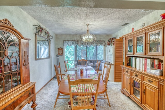 carpeted dining space featuring a notable chandelier and a textured ceiling