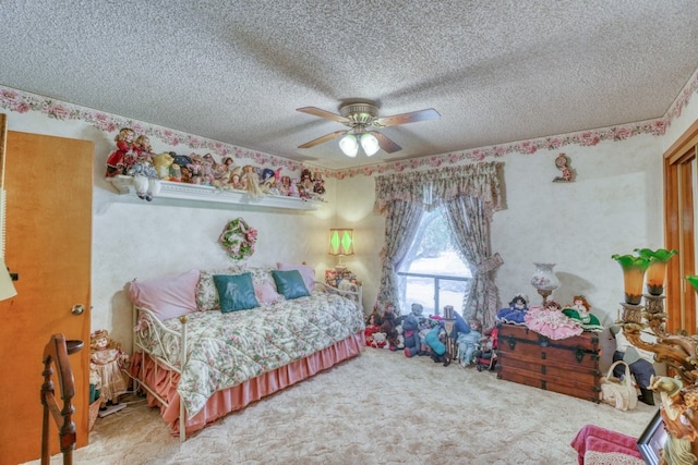 bedroom featuring ceiling fan, a textured ceiling, and carpet flooring