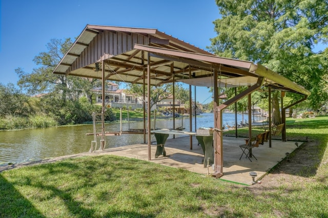 surrounding community with a water view and a yard