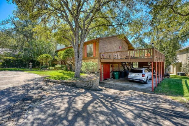 view of front of property with a front lawn, a carport, and a deck