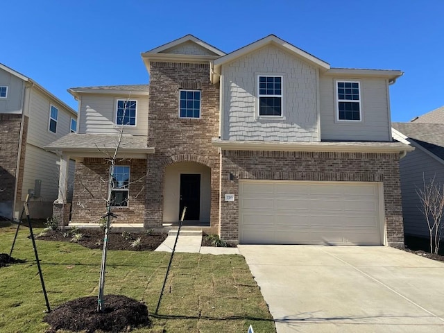 view of front of property with a front yard and a garage