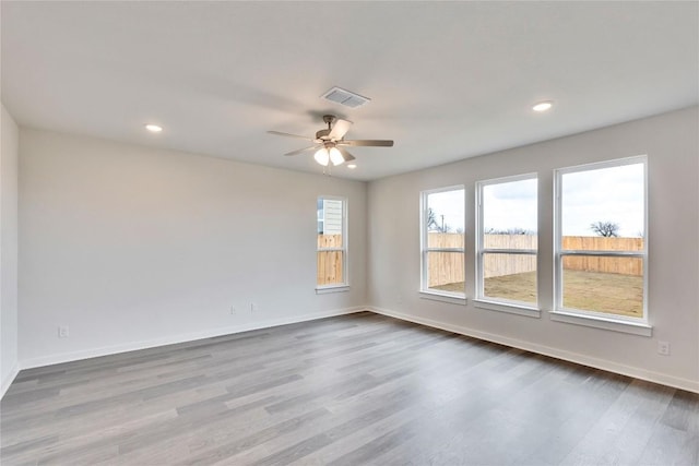 unfurnished room with visible vents, baseboards, and dark wood-style floors