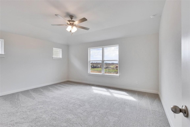 spare room with ceiling fan, baseboards, and carpet