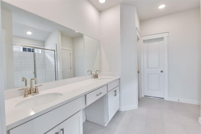 bathroom featuring a sink, recessed lighting, a stall shower, and double vanity