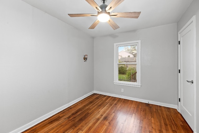 spare room with ceiling fan and dark hardwood / wood-style floors