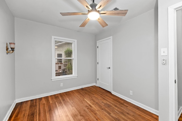 empty room featuring wood-type flooring and ceiling fan