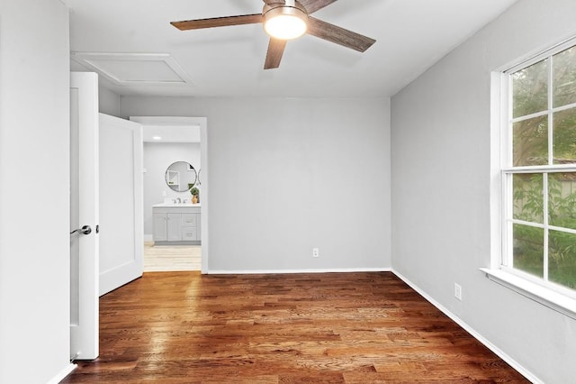 1708 Payne Ave, Austin, TX 78757 - unfurnished room with a ceiling fan, attic access, wood finished floors, a sink, and baseboards