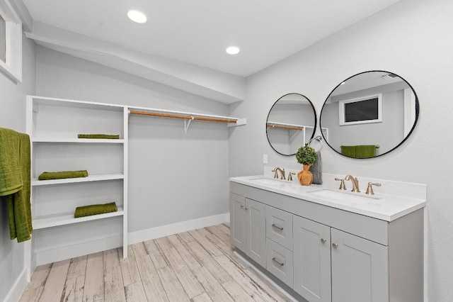 1708 Payne Ave, Austin, TX 78757 - full bathroom with double vanity, wood finished floors, baseboards, and recessed lighting