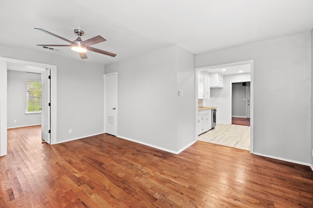 empty room featuring ceiling fan and hardwood / wood-style flooring