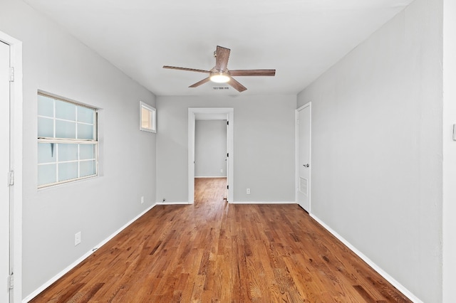 empty room featuring ceiling fan and hardwood / wood-style flooring