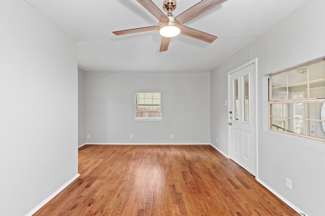 spare room featuring light hardwood / wood-style flooring and ceiling fan