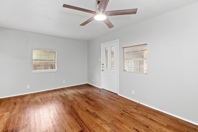 empty room with hardwood / wood-style floors and ceiling fan