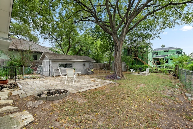 view of yard with a fire pit and a patio