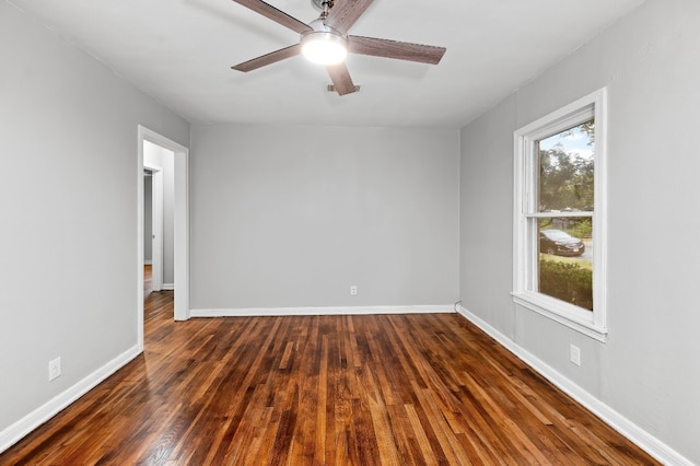 spare room featuring dark hardwood / wood-style floors and ceiling fan