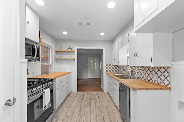 kitchen featuring white cabinetry, sink, light hardwood / wood-style flooring, and stainless steel appliances