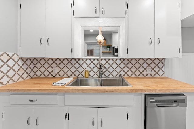 kitchen featuring dishwasher, white cabinetry, sink, and tasteful backsplash