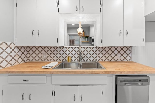 1708 Payne Ave, Austin, TX 78757 - kitchen with dishwasher, a sink, decorative backsplash, and white cabinetry